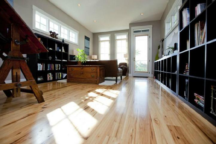Modern home office with hardwood flooring and built-in wood shelving